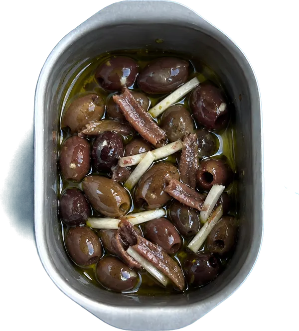 Nel primo contenitore mettete 20 g di olio extravergine di oliva, 50 g di olive taggiasche denocciolate intera, 4 filetti di acciughe sott'olio a pezzetti e 1 spicchio di aglio fresco a julienne.